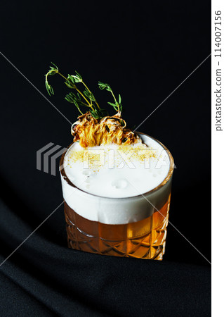 Alcoholic drink. A cocktail with elite alcohol on dark black background 114007156