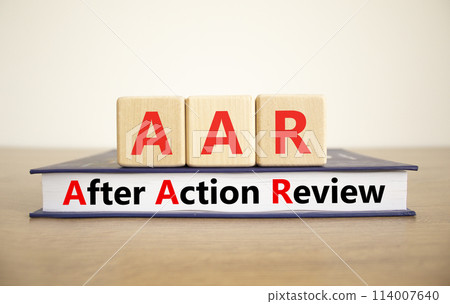 AAR After action review symbol. Concept words AAR After action review on beautiful wooden blocks and book. Beautiful white background. Business AAR after action review concept. Copy space. 114007640