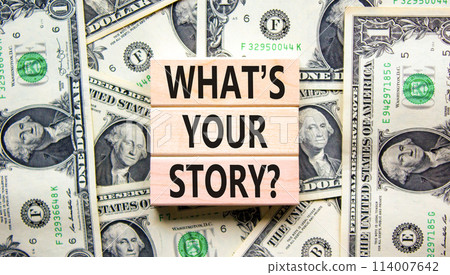 Storytelling and what is your story symbol. Concept words What is your story on blocks. Dollar bills. Beautiful dollar bills background. Business storytelling what is your story concept. Copy space. Storytelling and what is your story symbol. Concept words What is your story on blocks. Dollar bills. Beautiful dollar bills background. Business storytelling what is your story concept. Copy space. 114007642