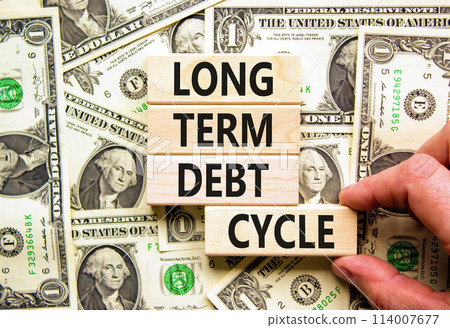 Long term debt cycle symbol. Concept words Long term debt cycle on beautiful wooden block. Beautiful dollar bills background. Dollar bills. Business Long term debt cycle concept Copy space 114007677
