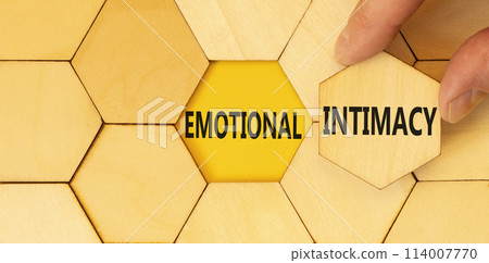Emotional intimacy symbol. Concept words Emotional intimacy on beautiful wooden puzzle. Beautiful yellow table yellow background. Psychologist hand. Psychology emotional intimacy concept. Copy space. 114007770
