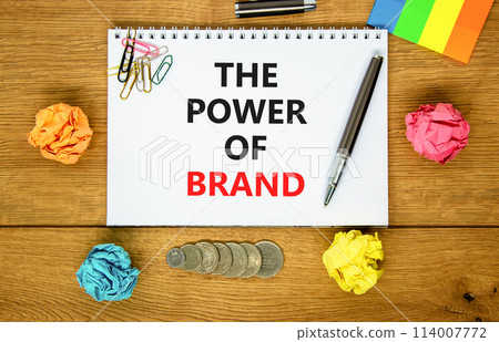 The power of brand symbol. Concept words The power of brand on beautiful white note. Beautiful wooden table background. Colored paper. Black pen. Business the power of brand concept. Copy space. 114007772