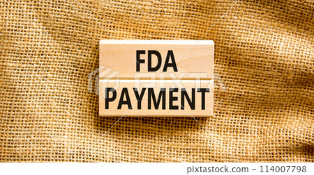 FDA Food and Drug Administration payment symbol. Concept words FDA payment on beautiful wooden blocks. Beautiful canvas table canvas background. Business FDA payment concept. Copy space. FDA Food and Drug Administration payment symbol. Concept words FDA payment on beautiful wooden blocks. Beautiful canvas table canvas background. Business FDA payment concept. Copy space. 114007798