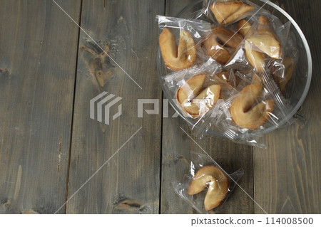 Fortune cookies in a bowl on a gray background with copyspace. 2 3 of the free space. New Year's Eve Traditions Fortune cookies in a bowl on a gray background with copyspace. 2 3 of the free space. New Year's Eve Traditions 114008500