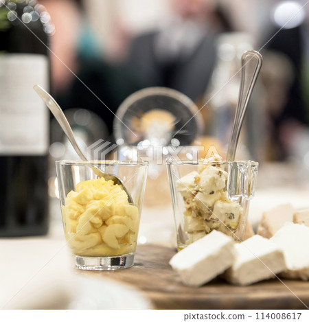 Wooden plate with cheese antipasti Wooden plate with cheese antipasti 114008617