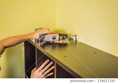 Frustrated Man Putting Together Self Assembly Furniture Frustrated Man Putting Together Self Assembly Furniture 114011193