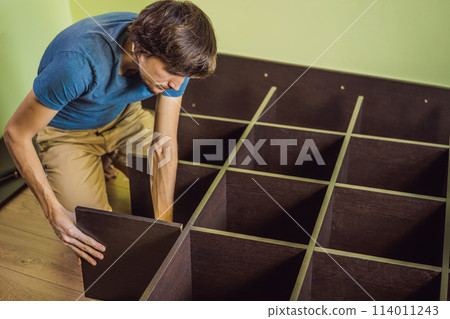 Frustrated Man Putting Together Self Assembly Furniture Frustrated Man Putting Together Self Assembly Furniture 114011243