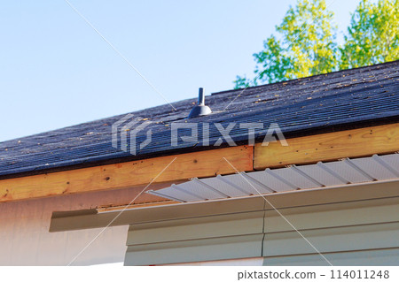 Aluminum fascia trim blown off damage exposed wood showing after hurricane storm 114011248