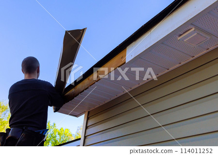Master makes repairs in aftermath of hurricane, exposed wood was left after aluminum fascia trim was blown off Master makes repairs in aftermath of hurricane, exposed wood was left after aluminum fascia trim was blown off 114011252