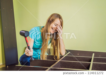 Caucasian woman using screwdriver for assembling furniture 114011272