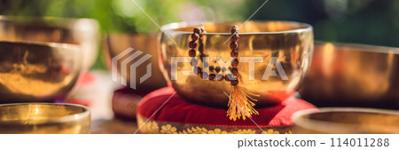 Tibetan singing bowls on a straw mat BANNER, LONG FORMAT Tibetan singing bowls on a straw mat BANNER, LONG FORMAT 114011288