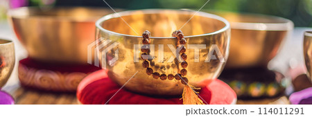 Tibetan singing bowls on a straw mat BANNER, LONG FORMAT 114011291