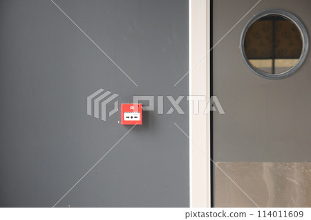 Red fire alarm button on wall , 114011609
