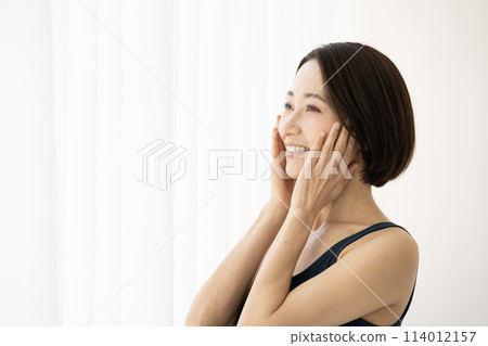 Profile of a woman with her hand on her cheek Profile of a woman with her hand on her cheek 114012157