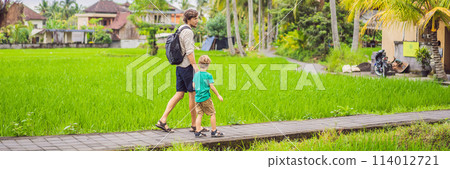 Dad and son travelers on Beautiful Rice Terraces against the background of famous volcanoes in Bali, Indonesia Traveling with children concept BANNER, LONG FORMAT Dad and son travelers on Beautiful Rice Terraces against the background of famous volcanoes in Bali, Indonesia Traveling with children concept BANNER, LONG FORMAT 114012721