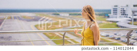 Start of her journey. Beautiful young woman ltraveler in a yellow dress and a yellow suitcase is waiting for her flight BANNER, LONG FORMAT Start of her journey. Beautiful young woman ltraveler in a yellow dress and a yellow suitcase is waiting for her flight BANNER, LONG FORMAT 114012844
