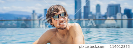 Man relax in swimming pool in sunrise, on rooftop in the city. Rich people BANNER, LONG FORMAT Man relax in swimming pool in sunrise, on rooftop in the city. Rich people BANNER, LONG FORMAT 114012853