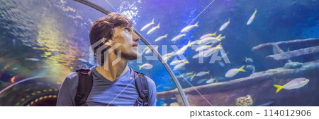 curious tourist watching with interest on shark in oceanarium tunnel BANNER, LONG FORMAT 114012906