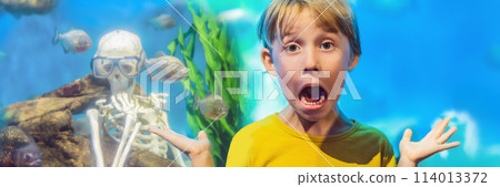 The boy got scared Skeleton and piranha in an aquarium BANNER, LONG FORMAT 114013372