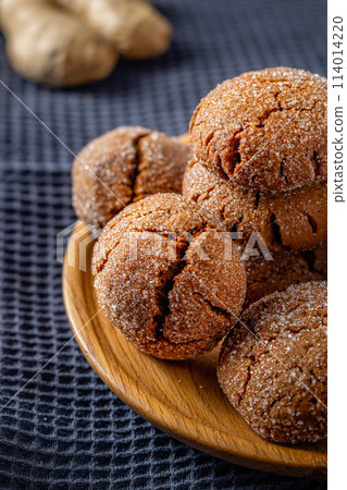 Warm Homemade Gingersnap Cookies on a gray handkerchief Warm Homemade Gingersnap Cookies on a gray handkerchief 114014220