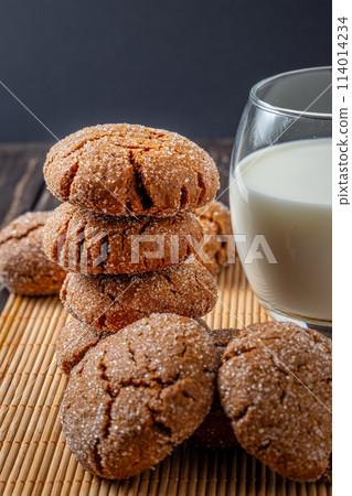 Warm Homemade Gingersnap Cookies gray towel and milk Warm Homemade Gingersnap Cookies gray towel and milk 114014234