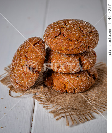 Warm Homemade Gingersnap Cookies on a wooden board Warm Homemade Gingersnap Cookies on a wooden board 114014237