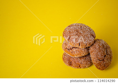Warm Homemade Gingersnap Cookies yellow background 114014290