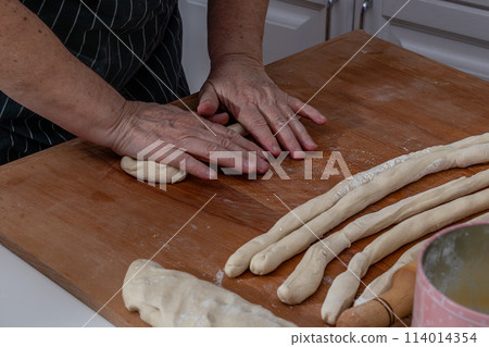 Women's hands knead the dough for dumplings Women's hands knead the dough for dumplings 114014354