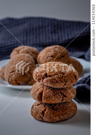 Warm Homemade Gingersnap Cookieson a light background, a gray handkerchief 114014368