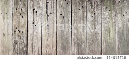 A horizontal background image of an exterior wall made of faded light brown wood-grained railroad ties A horizontal background image of an exterior wall made of faded light brown wood-grained railroad ties 114015716