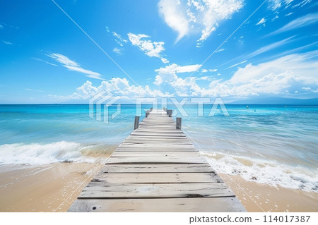 Sundrenched beach and wooden pier under a bright blue sky, perfect for a tranquil day by the sea Sundrenched beach and wooden pier under a bright blue sky, perfect for a tranquil day by the sea 114017387