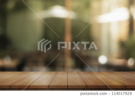 Empty wooden table top with lights bokeh on blur restaurant background. Empty wooden table top with lights bokeh on blur restaurant background. 114017929