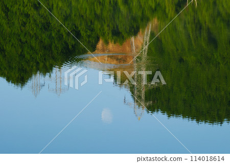 Ripples on the lake surface and the power transmission tower and moon reflected on the lake surface Ripples on the lake surface and the power transmission tower and moon reflected on the lake surface 114018614