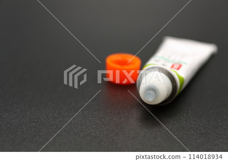A partially used tube of ointment 114018934