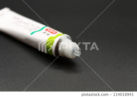 A partially used tube of ointment 114018941