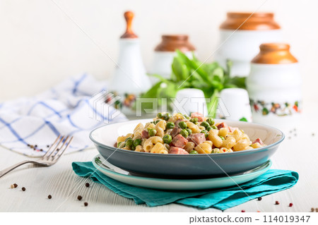 Homemade pasta with green peas and ham. Homemade pasta with green peas and ham. 114019347