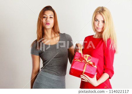 Two beautiful women with red gift box Two beautiful women with red gift box 114022117
