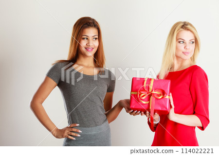 Two beautiful women with red gift box Two beautiful women with red gift box 114022221