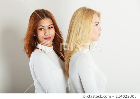 Blonde and dark friends together. 114022305