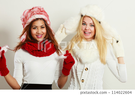 Two smiling girls in warm winter clothing. Two smiling girls in warm winter clothing. 114022604