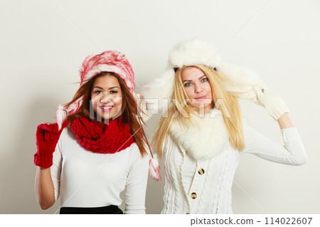 Two smiling girls in warm winter clothing. Two smiling girls in warm winter clothing. 114022607