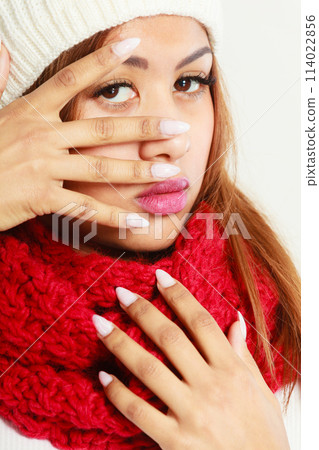 Mulatto woman in warm winter clothing showing nails 114022856