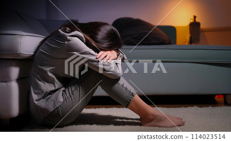 Depressed Woman Sitting Alone on the Floor in a Dark Room - Generative Ai 114023514