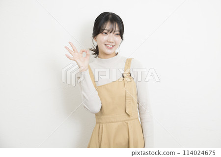 Young woman doing ok sign 114024675