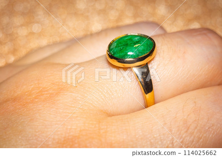 Gold ring with green stone 114025662