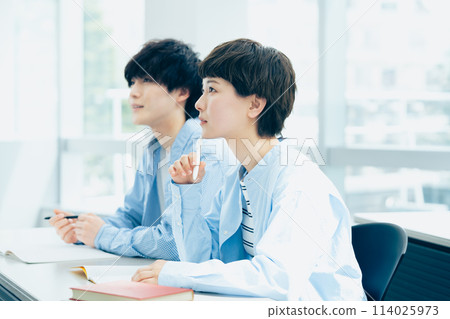 Young men and women receiving a lecture Young men and women receiving a lecture 114025973