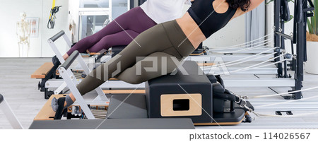 Woman doing pilates, woman stretching 114026567