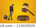 Distressed young man chained to shackle ball and huge browngavel 114028926