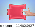 Hand pointing to a floating, divided pillow 114028927