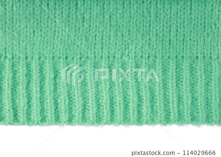 Green knitted woolen jersey fabric, sweater texture with edge isolated on white background Green knitted woolen jersey fabric, sweater texture with edge isolated on white background 114029666